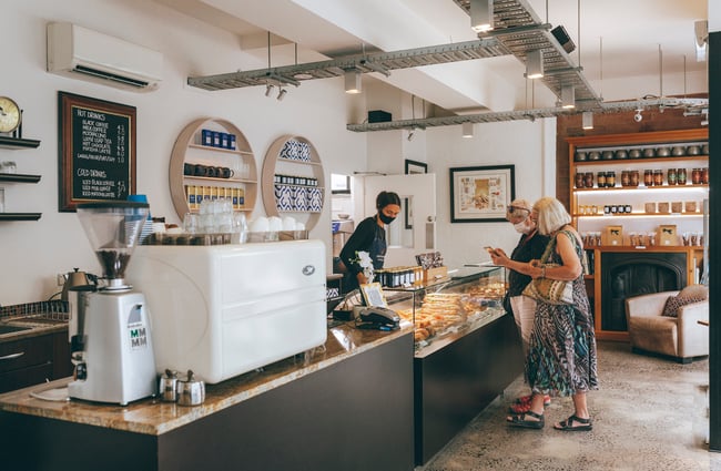 Two woman ordering at the counter at Vaniyé Pâtisserie, Auckland.