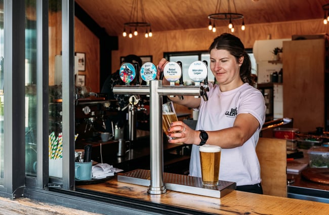 Bartender pouring a beer at Velo Café & Beer Garden.