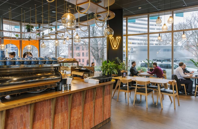 Barista counter and customers at tables at Vivace Espresso.