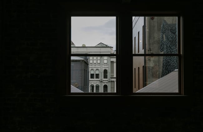 Dark interior looking out to historical building at Vogel Street Kitchen, Dunedin.