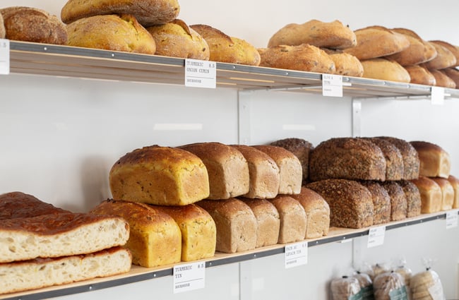 Bread stacked on shelves at Volare Bread.