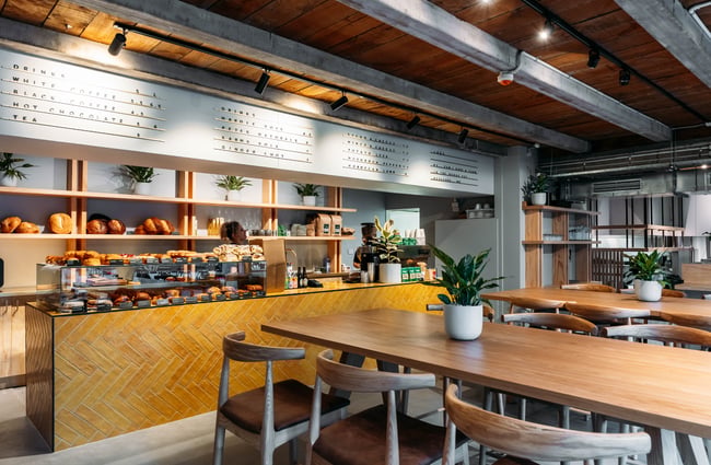 Cabinet of pastries and cafe seating area at Volco Egmont Street.