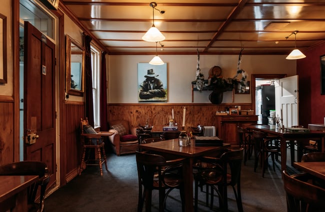 A seating area inside a dark restaurant.