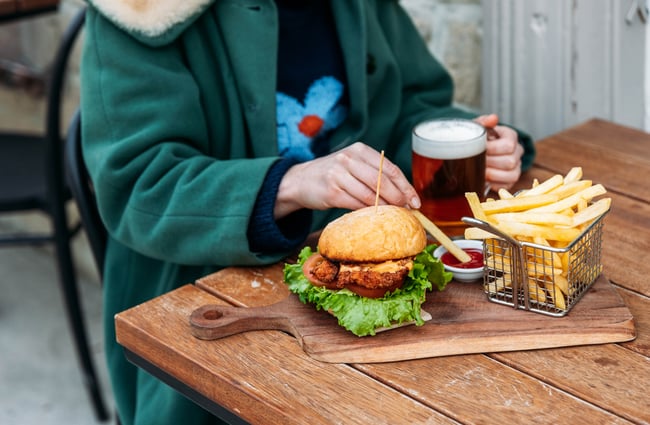 Burgers and chips on a table.