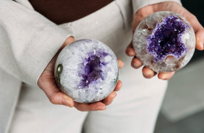 Sales assistant holding some crystals at VVITCHMOUNTAIN.