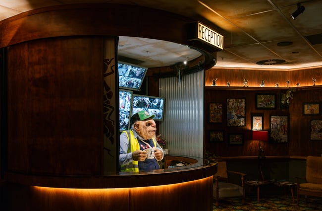 A creature at a movie counter booth.