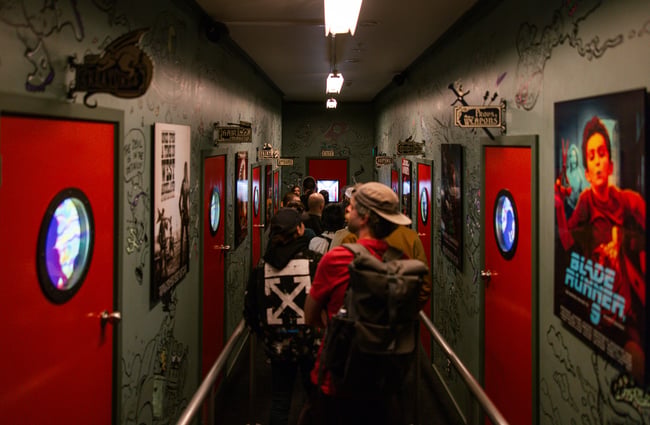 People walking down a corridor.