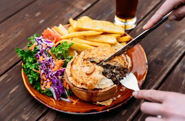 A close up of a pie being cut into.