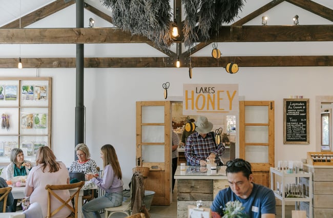 People sitting inside the Lavender Farm cafe enjoying a drink.