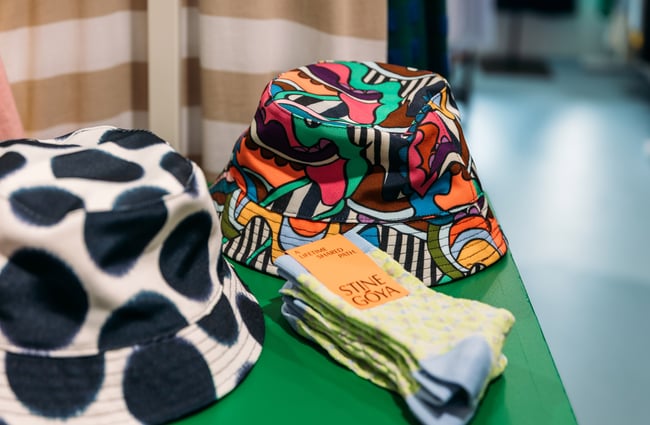 A close up of socks and hats on a shelf.