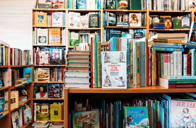 A close up of books on shelves.