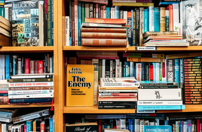 A close up of books on a shelf.