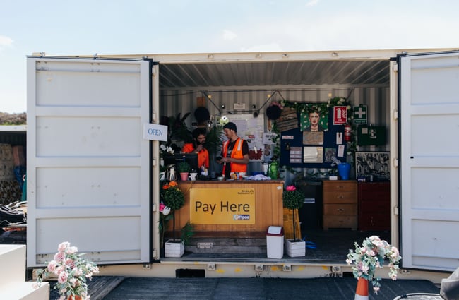 Two men chatting inside a container.