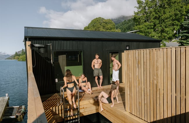 Friends gathering outside plunge pool at Watershed Saunas in Queenstown