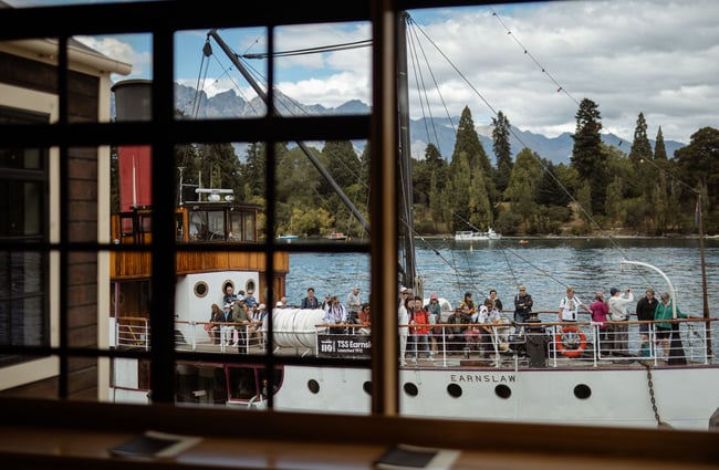 Boat arriving outside window at Wharf Bar in Queenstown