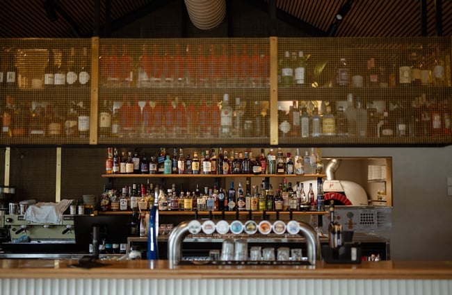 Liquor on shelves behind bar at Wharf Bar in Queenstown