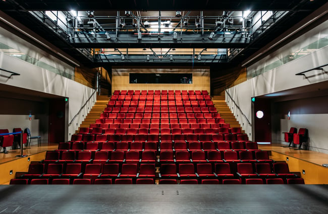 A large red seating area inside a gallery.