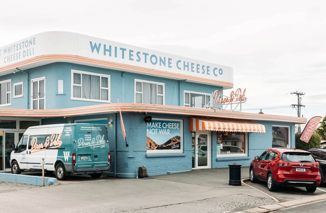 Blue and peach art deco exterior of Whitestone Cheese Deli & Diner in Ōamaru