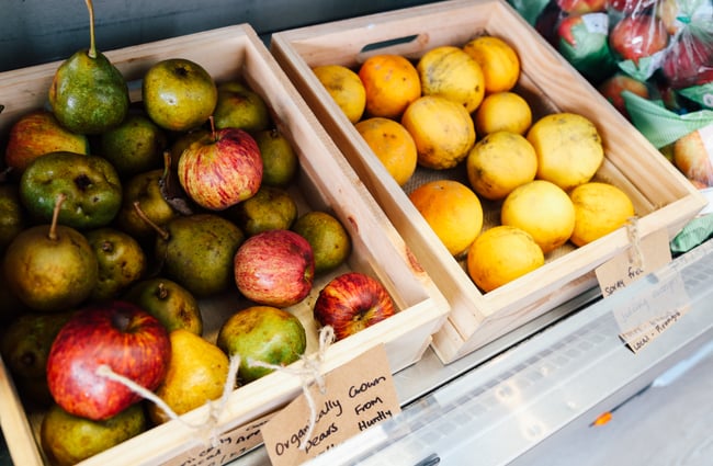 Fruit in wooden boxes on display.