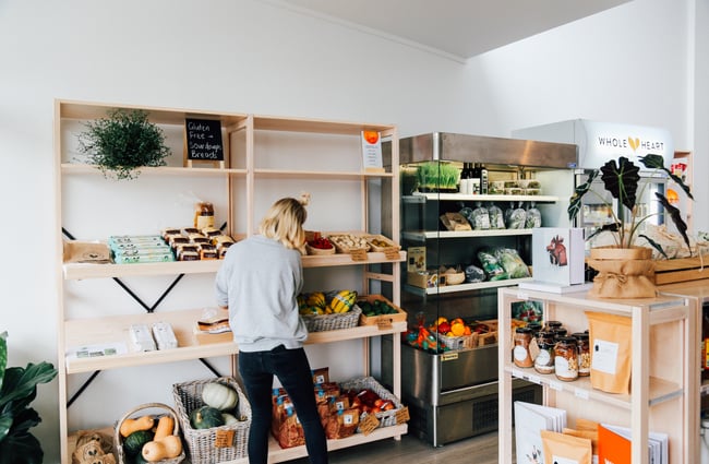 Worker tends to the products on shelves.