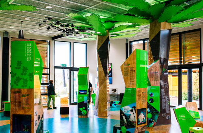 The foyer with fake big green trees going up onto the celling.