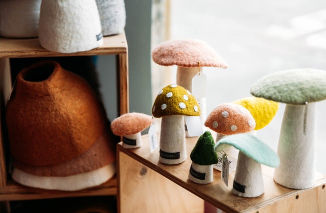 Close up of felted mushrooms on shelf at shop