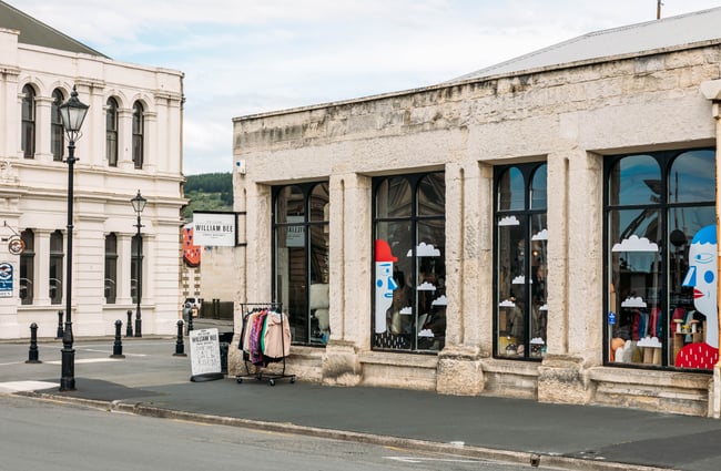 Stone exterior of William Bee in Ōamaru with colourful window art