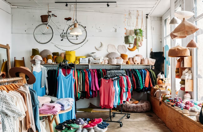 Overview of William Bee with women's clothing on racks and felted homewares on window shelf and hanging from the ceiling