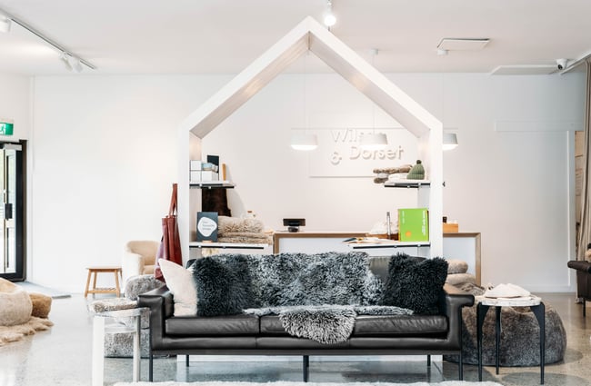 The front counter with a sofa in the foreground at Wilson & Dorset, Wānaka.