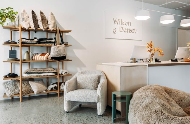 Interior of Wilson & Dorset with a woman working behind the counter.