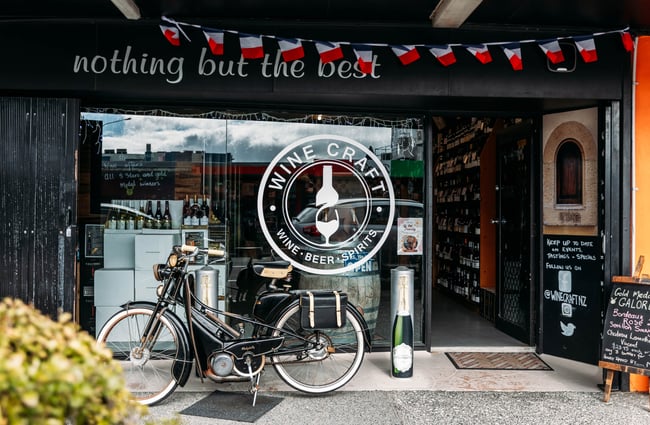 Shop frontage of WineCraft with bike outside the front door.