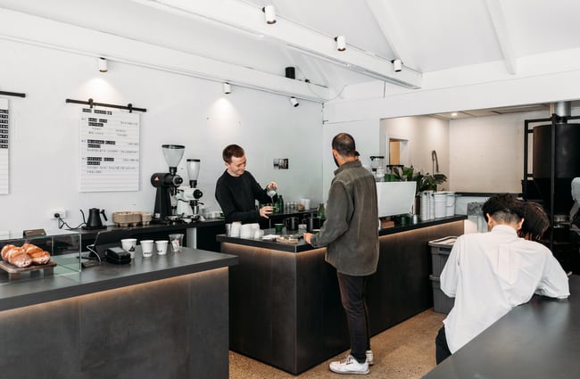 A customer being served at a cafe counter.