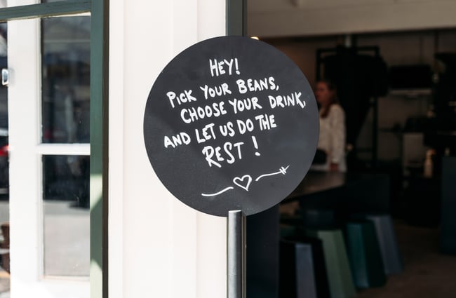 A black and white sign outside a building.