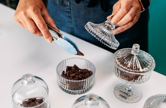 Shop assistant serving chocolate at Wonderland Chocolate.