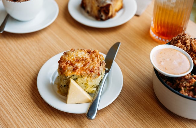 Scone on a plate with some butter at Wooden Spoon.