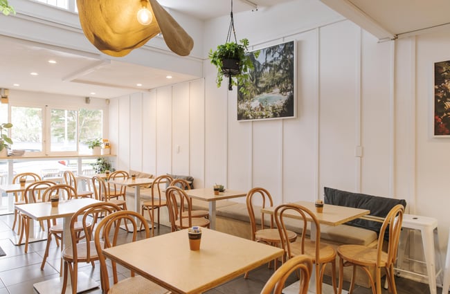 Tables and chairs in the dining space at Woods Cafe.