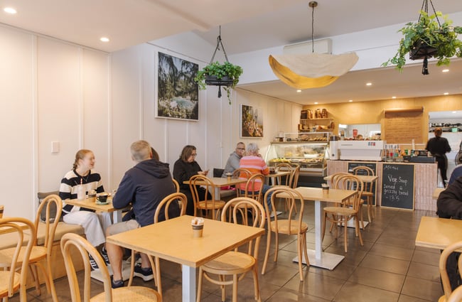 Busy cafe interior with customers at tables in Woods Cafe.