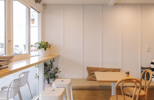 Bar seating by the window and bench seating at Woods Cafe.