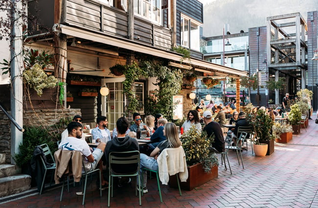 Customers dining outside on a sunny day.