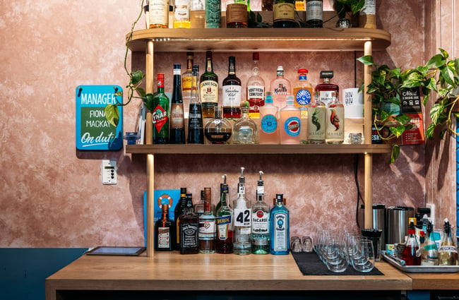 Bottles of liquor on shelves inside a bar.
