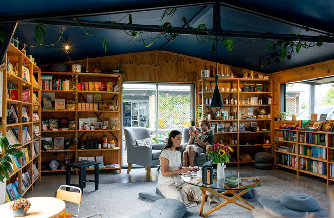 Two people sitting and reading at Hub Matakana.