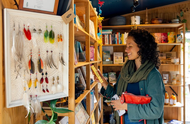 Customer browsing the shelves at Hub Matakana.