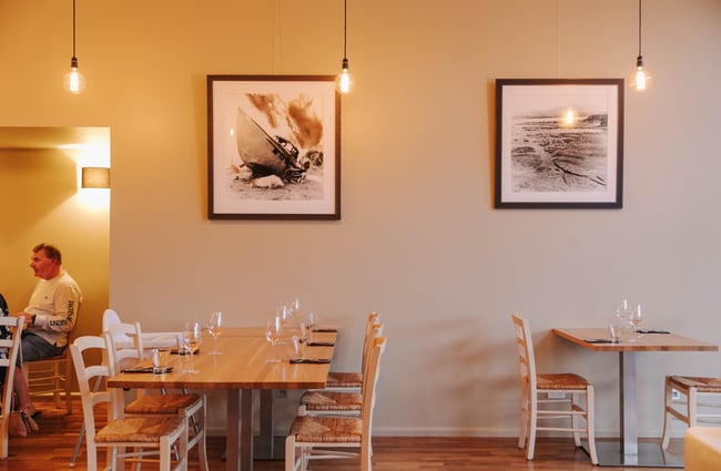 Table set at Zephyr with artwork hanging above.