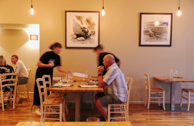 Waitress putting a menu on a table.