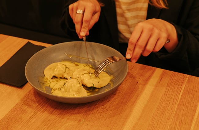 Woman about to eat her ravoli at Zephyr.