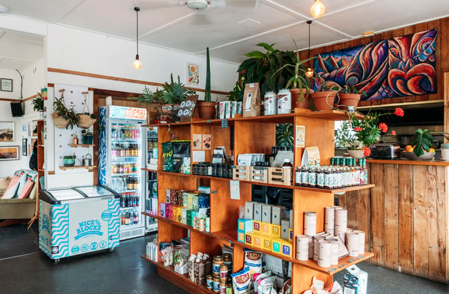 Homewares and kitchenwares on display on shelves inside a cafe.