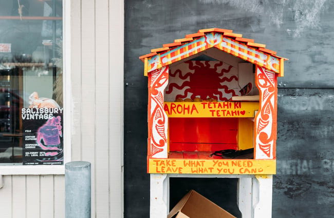 A small community library built out of wood.