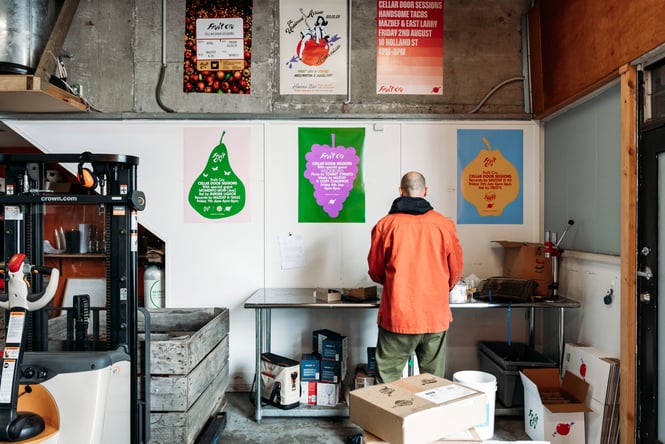 Cosmo with his back turned to the camera working in the production space of Fruit Cru.