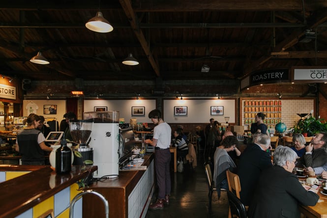 View of big table of customers at Addington Coffee Co-op in Christchurch.