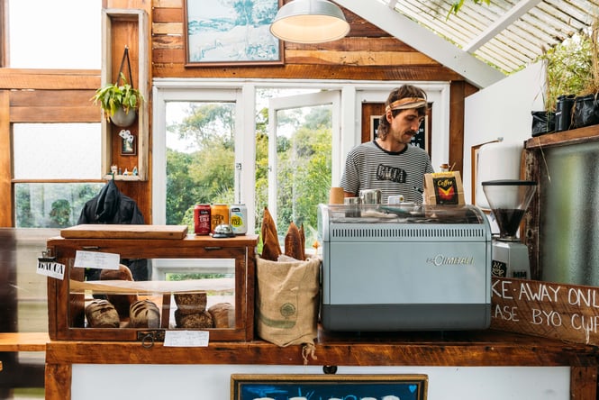 A staff member working behind the counter in the Bacca Bakery cafe.